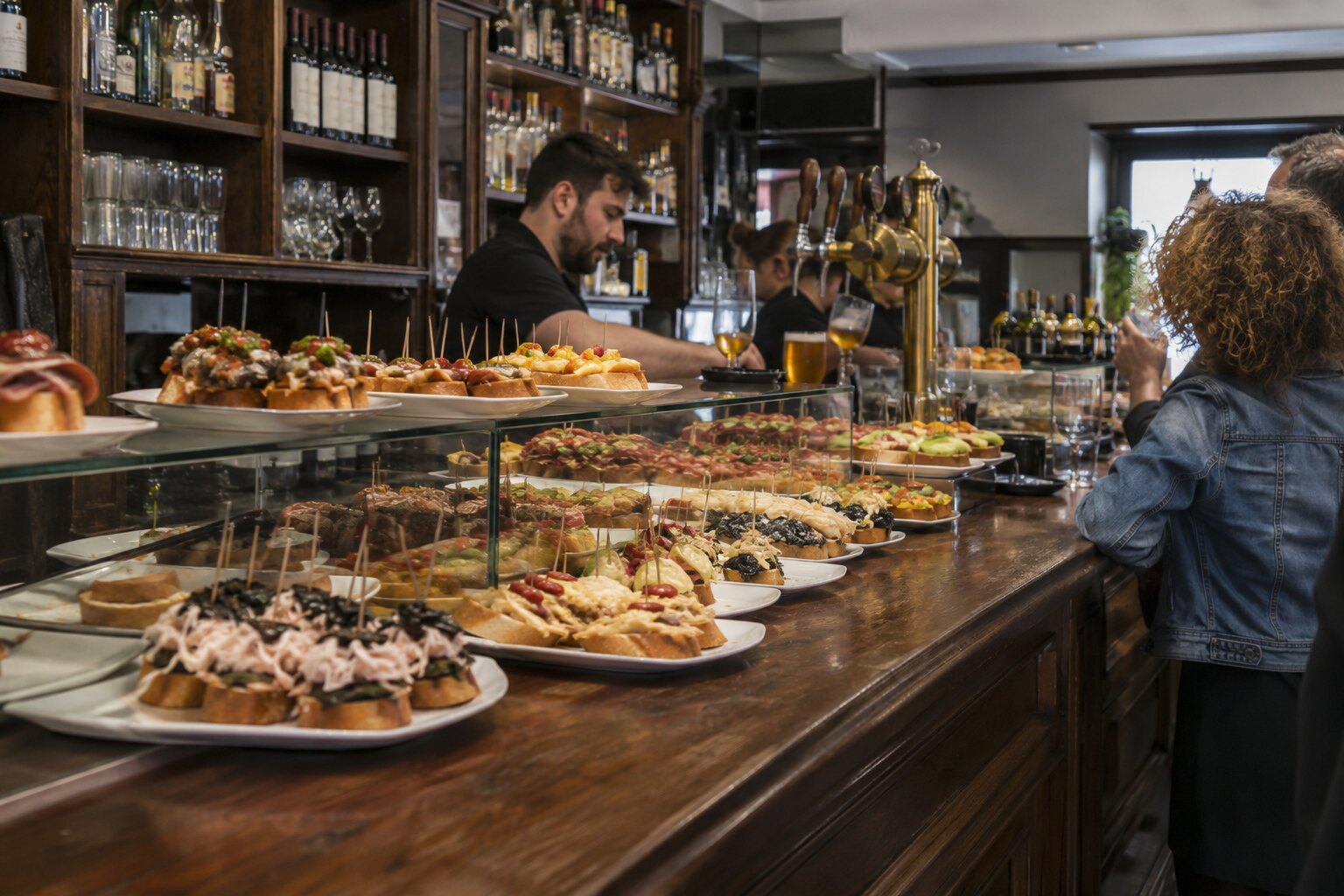 The pintxos counter and beer taps at G cafe Bilbao