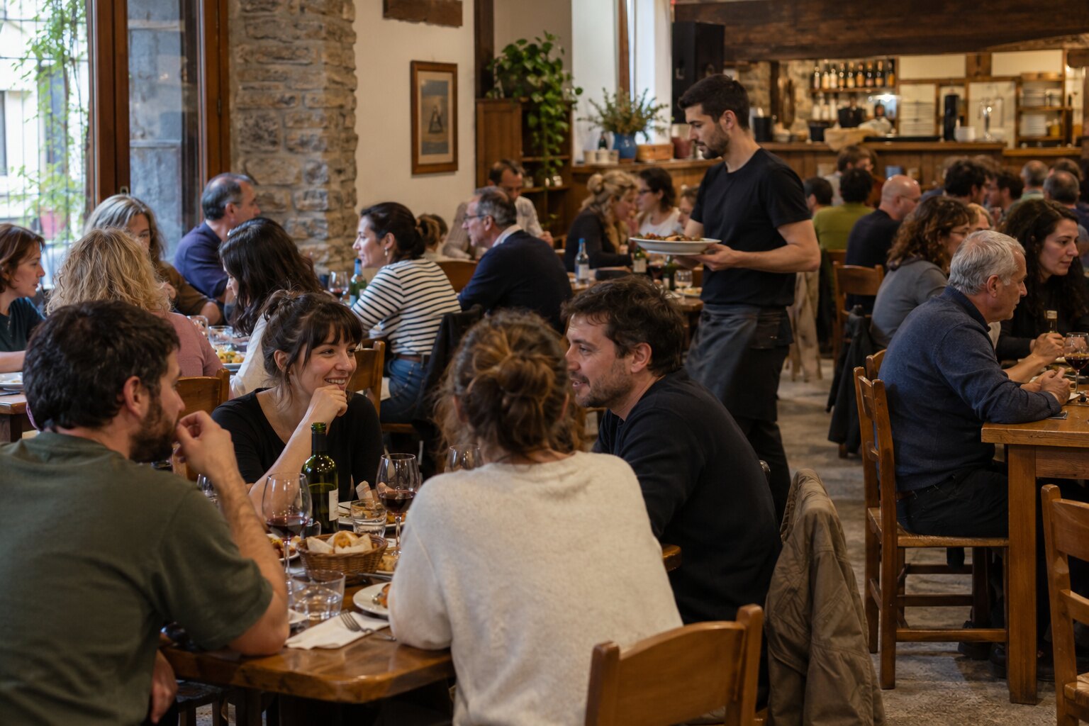 G cafe Bilbao full on a weekend evening, warm light over packed tables