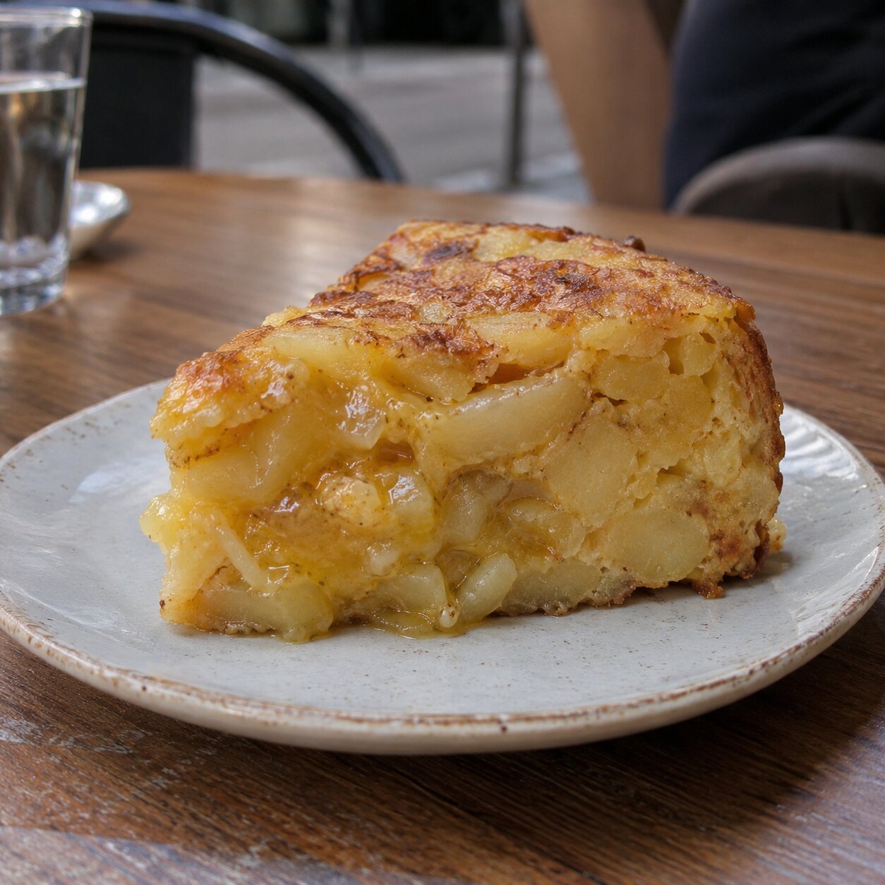 A thick slice of Spanish potato tortilla, runny in the centre