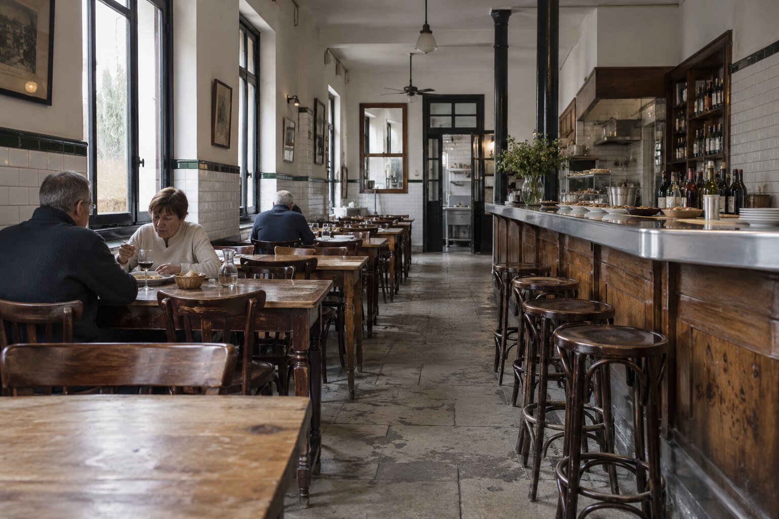 Inside G cafe Bilbao — tiled bar, worn wooden tables and warm lamplight
