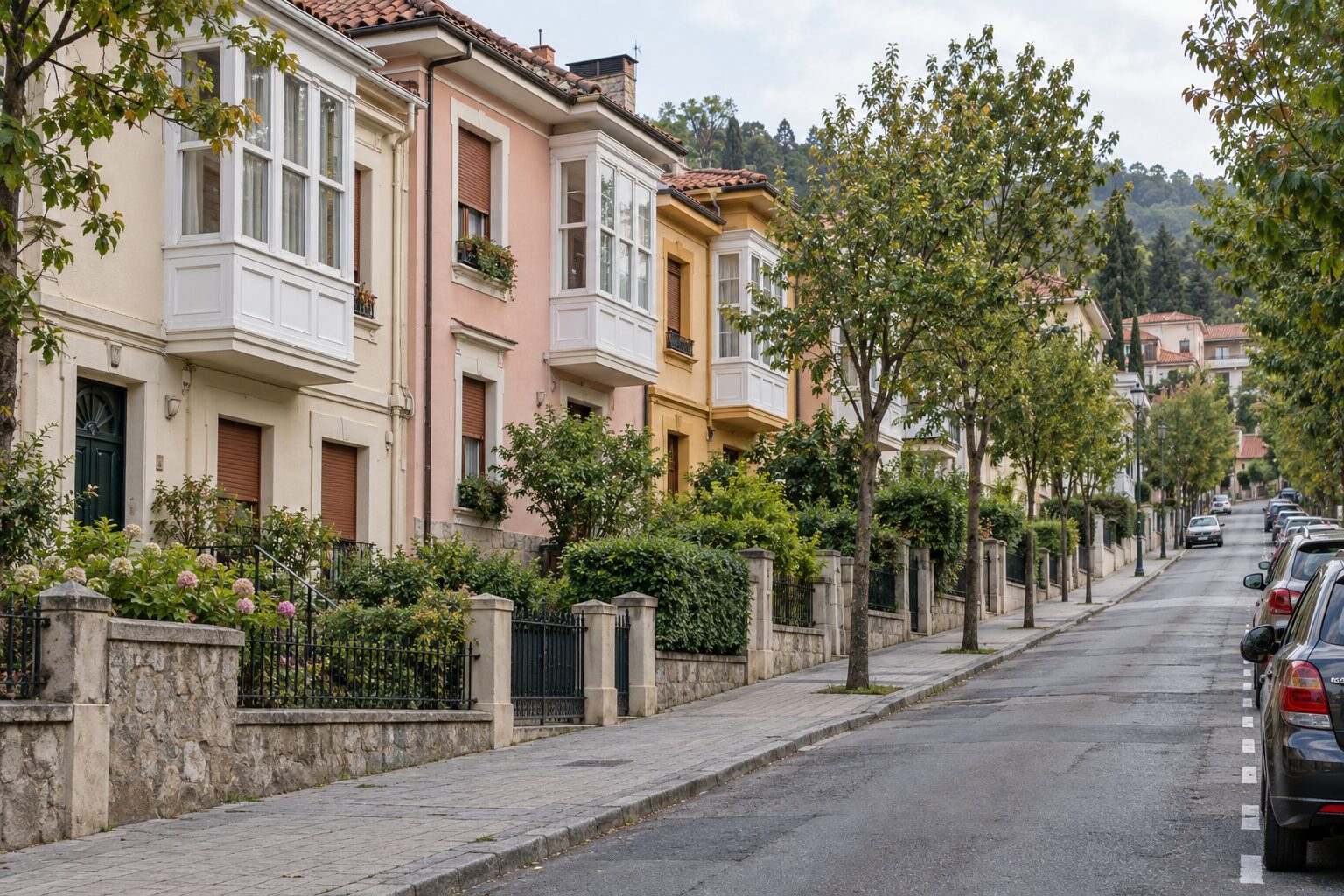 The quiet Irala street outside G cafe Bilbao — low pastel houses with glazed bay windows