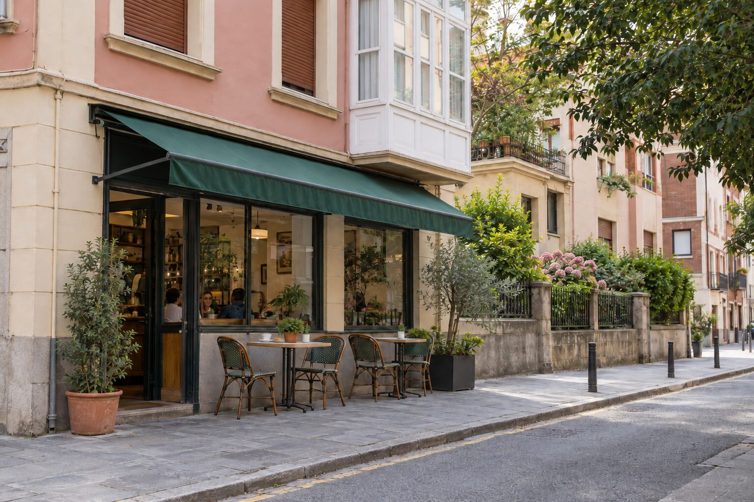 Terrace tables under the awning at G cafe Bilbao on a sunny afternoon